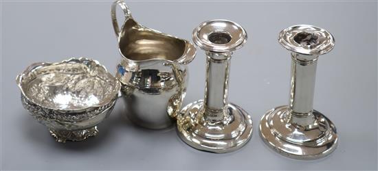 A George III silver helmet cream jug, a 1920s imported German silver bowl and a pair of silver dwarf candlesticks(a.f.).